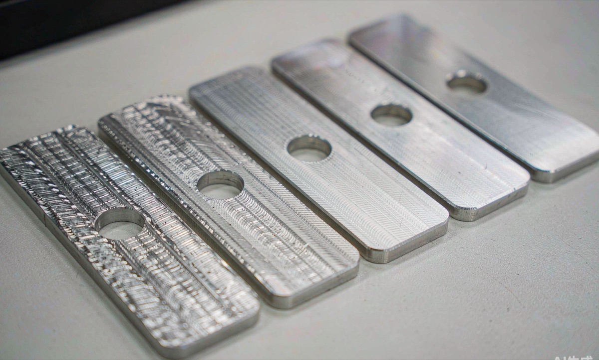Aluminium test coupons showing CNC machined surface finishes from rough milling to polished