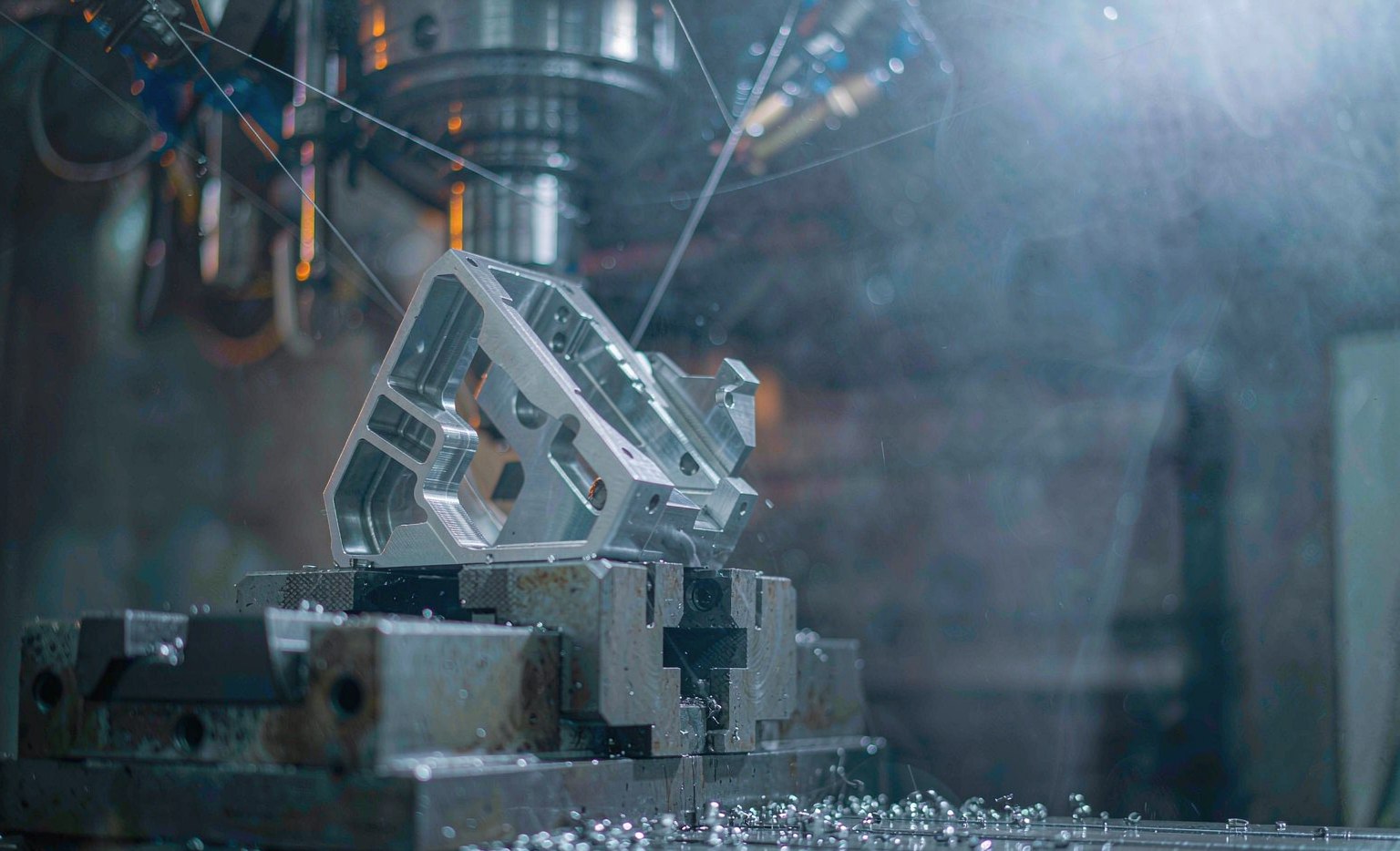 Ti-6Al-4V titanium bracket held in a CNC milling vise during machining
